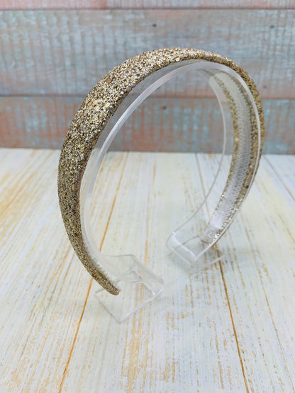 Diadema con glitter dorado